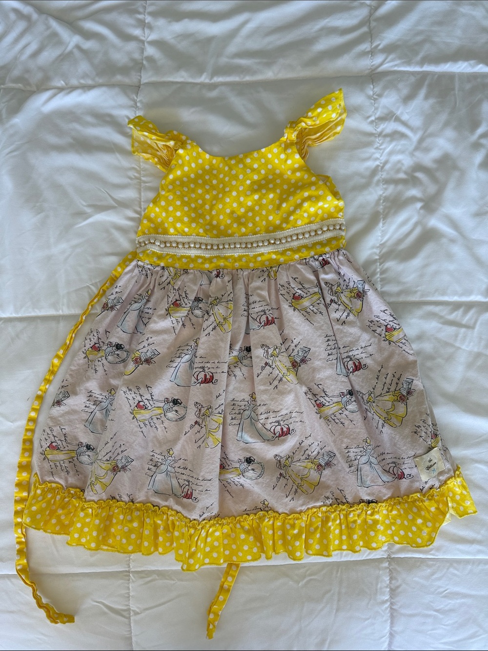Girls Disney Princess dress with yellow polka dot accents